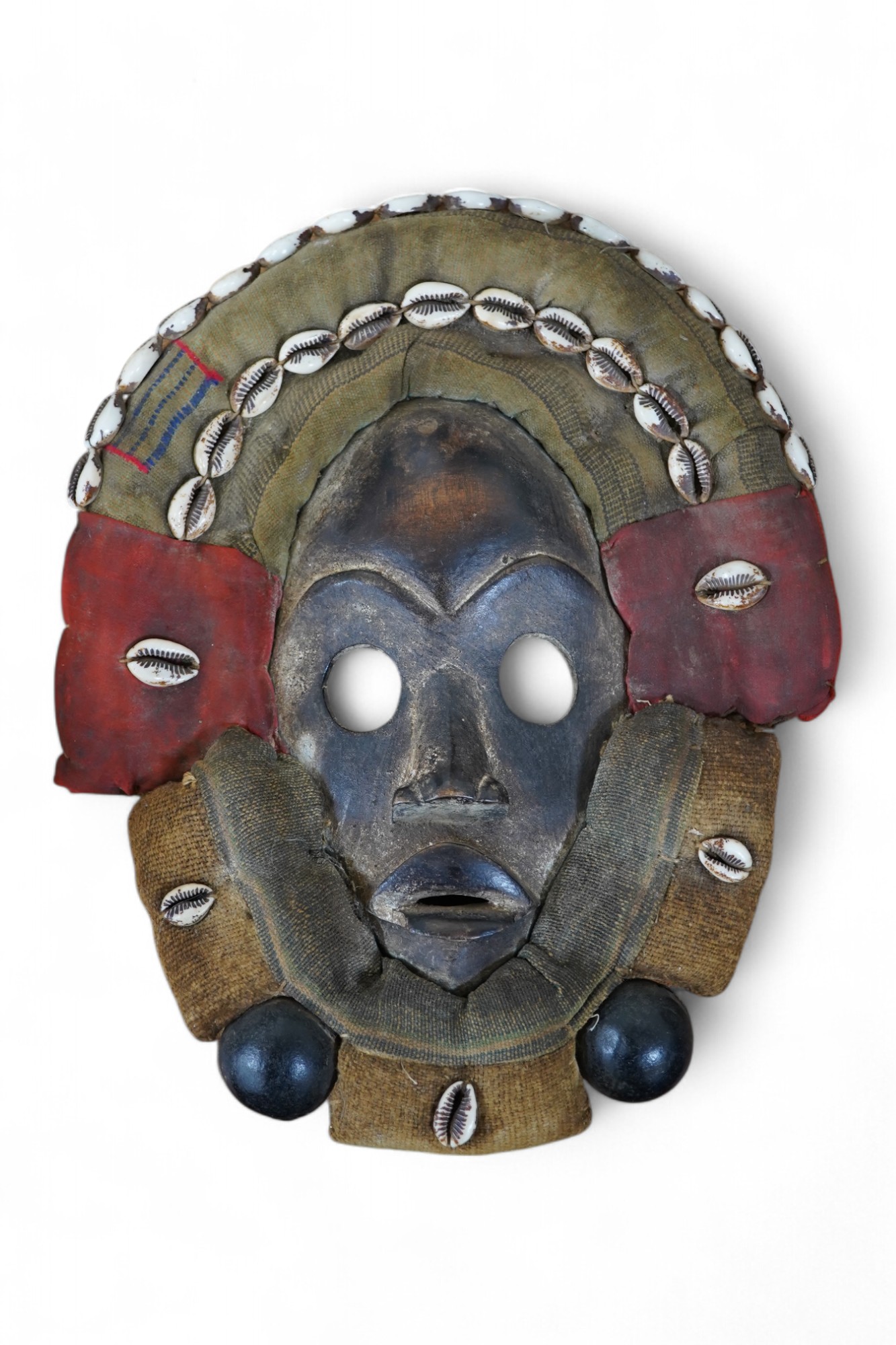 African art - a Liberian/Ivory Coast Dan mask with shell mounts together with another, largest 100cm. Condition - fair to good